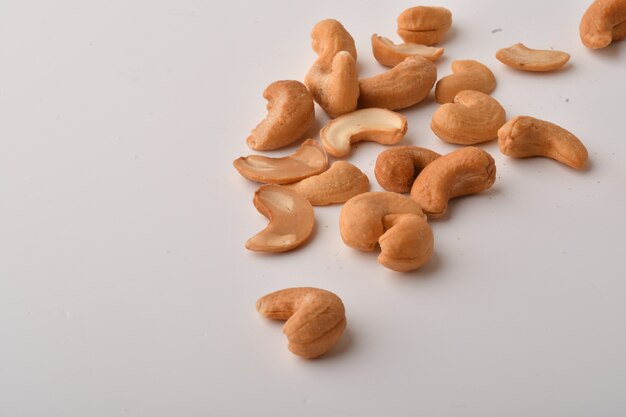 Heap of cashew nuts on white