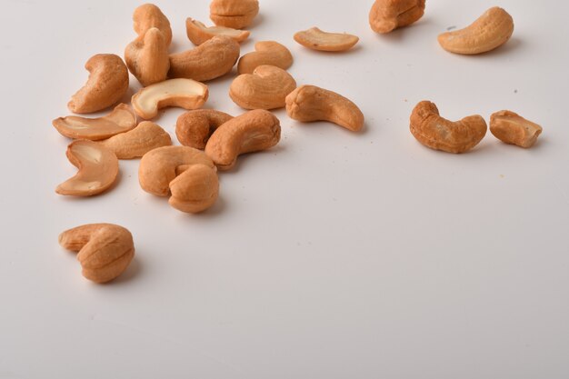 Heap of cashew nuts on white