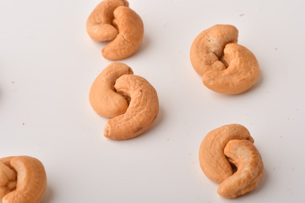 Heap of cashew nuts on white