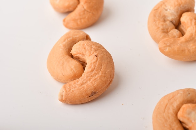 Heap of cashew nuts on white