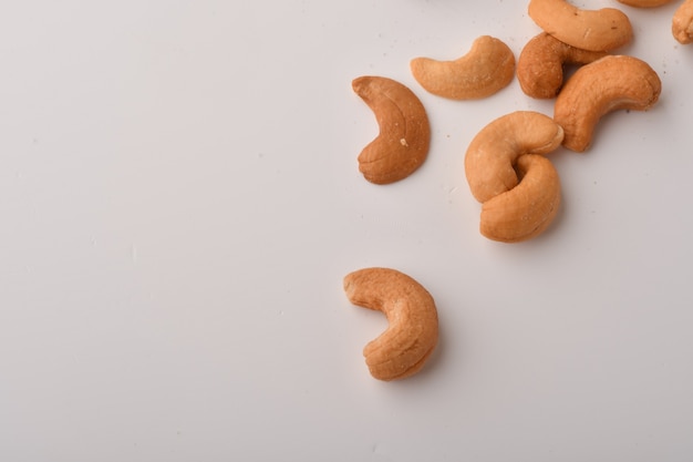 Heap of cashew nuts on white