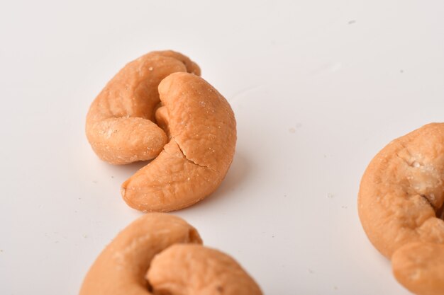 Heap of cashew nuts on white