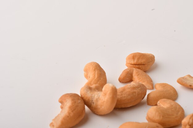 Heap of cashew nuts on white