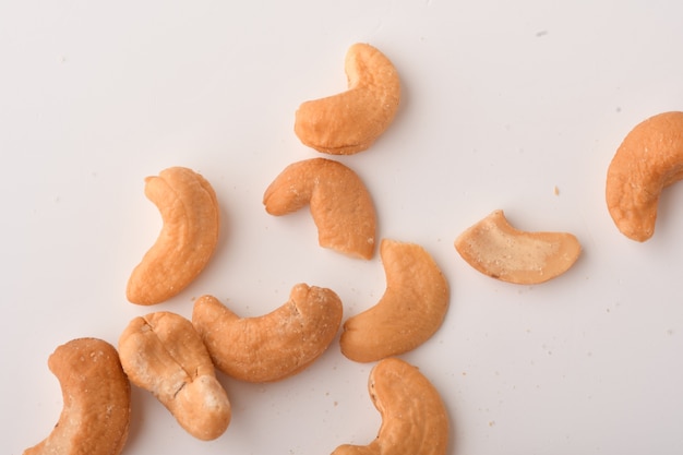 Heap of cashew nuts on white