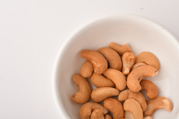 Heap of cashew nuts on white