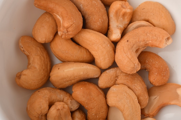 Heap of cashew nuts on white