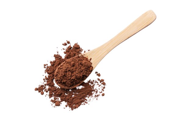 Heap of cocoa powder in a wooden spoon isolated on white background