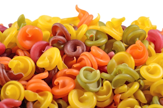 Heap of colored italian pasta on a white background