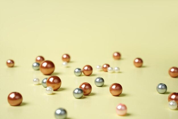 Heap of colored pearls on a beige background