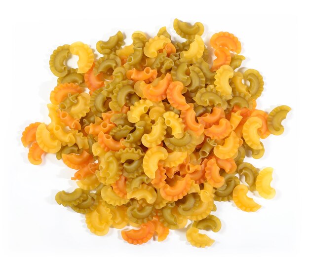 Heap of colored uncooked italian pasta on a white background