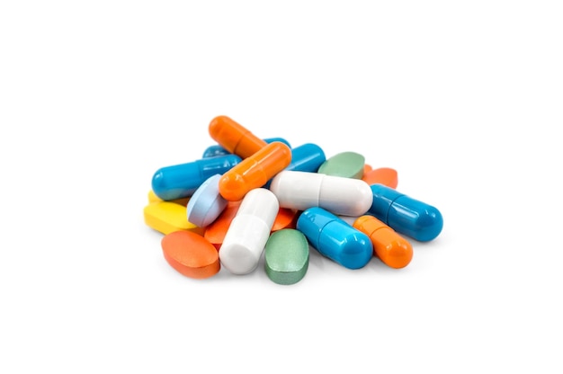 Heap of different colorful pills on a white