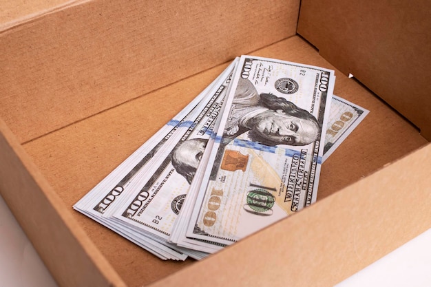 Heap of dollars in box on white background