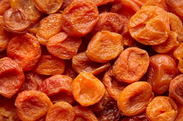 Heap of dried apricots fruits food background