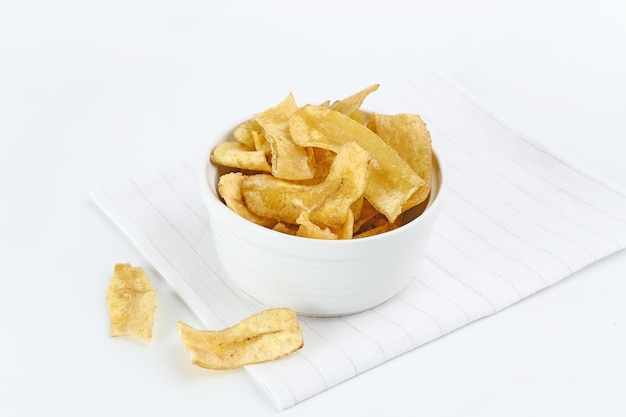Heap of dried banana chips snack on white background Selective focus image