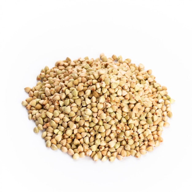 Heap of dried buckwheat seeds isolated on white background