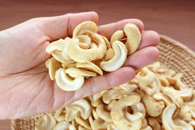 Heap of Dried Cashew Nut Kernels in Man's Hand