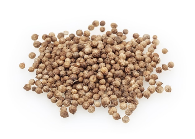 Heap of dried coriander seeds isolated on white background