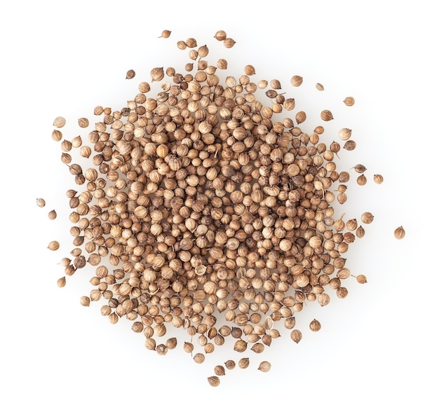 Heap of dried coriander seeds isolated on white background