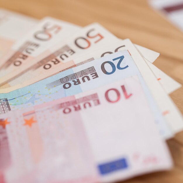 Heap of euro banknotes on a wooden table