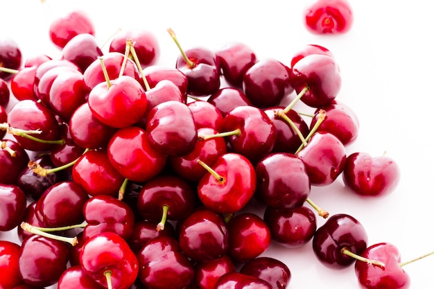 Heap of fresh cherries on a white background.