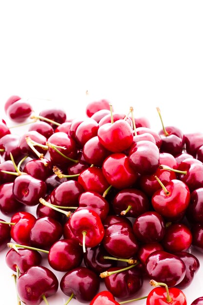 Heap of fresh cherries on a white background.