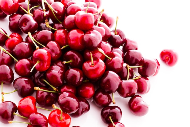 Heap of fresh cherries on a white background.