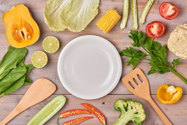 Heap of fresh fruits and vegetables on wooden background