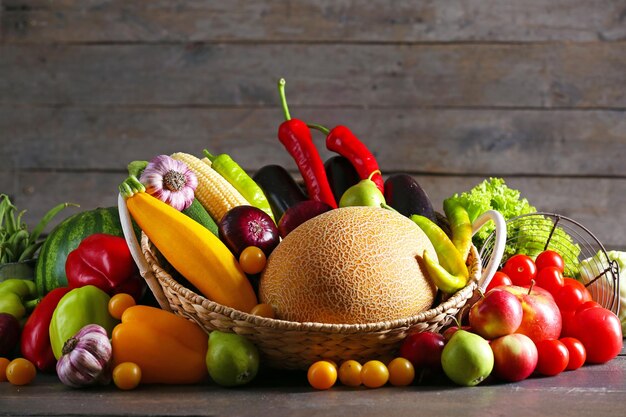 Heap of fresh fruits and vegetables on wooden background