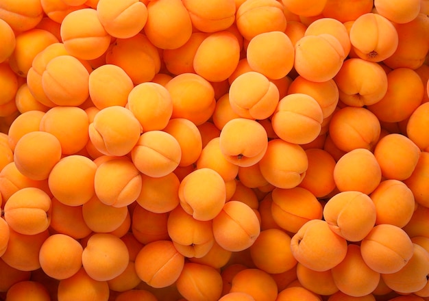 Heap of fresh ripe apricots top view fruit background with copy space ai generated