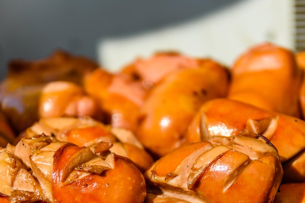 Heap of the fried sausages in steel tray