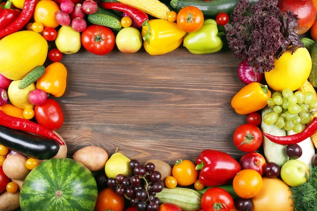 Heap of fruits and vegetables on wooden background