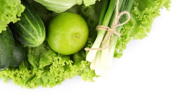 Heap of green vegetables isolated on white