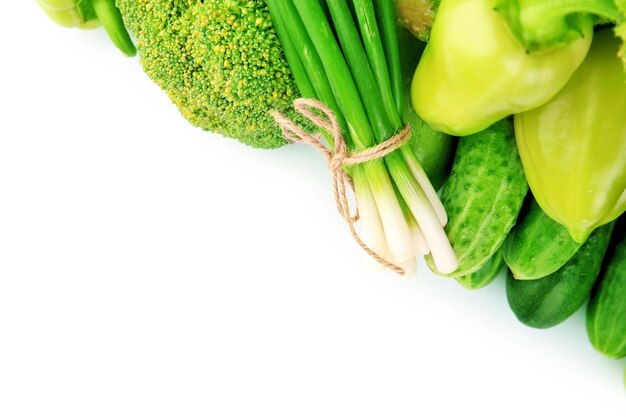 Heap of green vegetables isolated on white