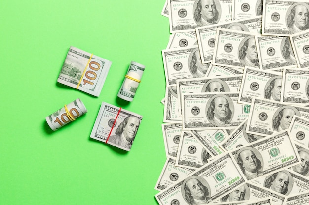 Heap of hundred Dollar Bills on colored background 