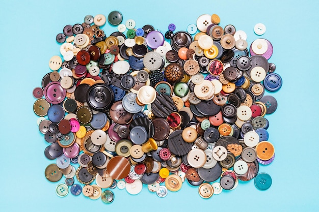 Heap of many various buttons on blue background