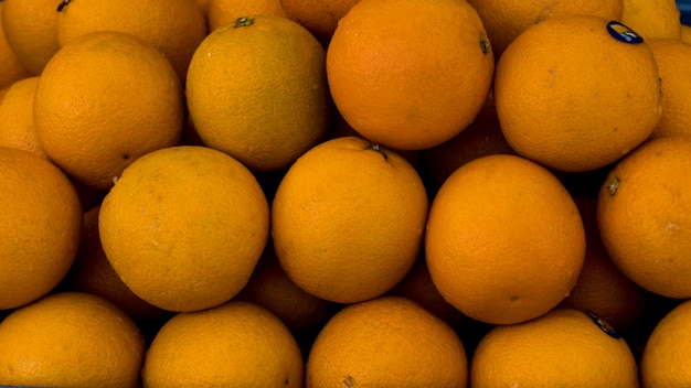 Heap of orange in the market Closeup Orange at market Deep yellow color orange