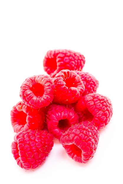 Heap of organic raspberries on white background.