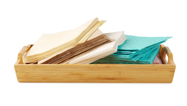 Heap of paper napkins on wooden tray on white background