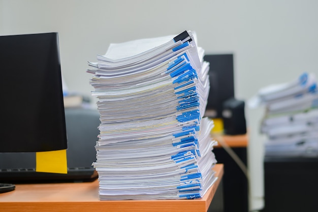 Heap of papers work stack documents on office desk