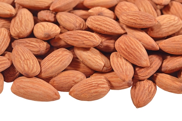 Heap of peeled almonds on a white background