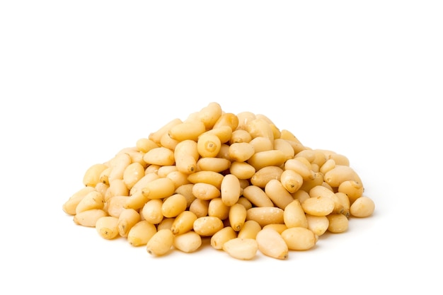Heap of pine nuts on white