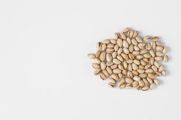 Heap of pistachios isolated on white background Overhead