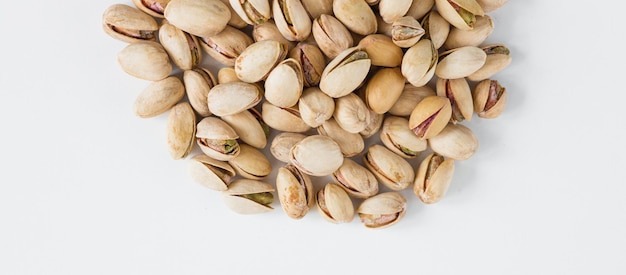 Heap of pistachios isolated on white background Overhead