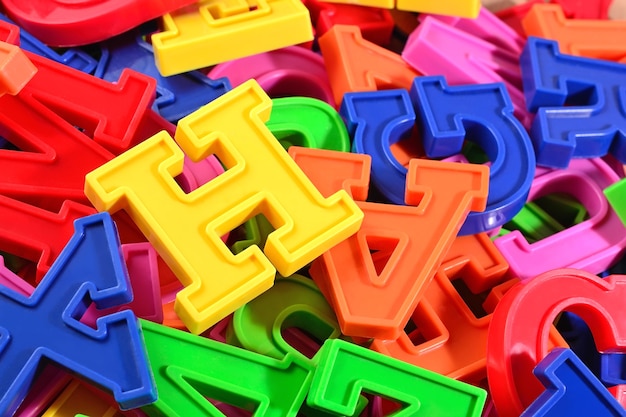 Heap of plastic colored alphabet letters close up