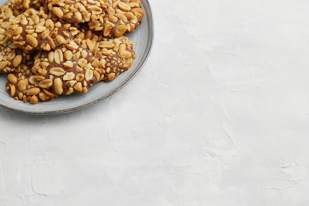 Photo a heap of portugues traditional peanut cookies known as bolachas de amendoim on the grey plate