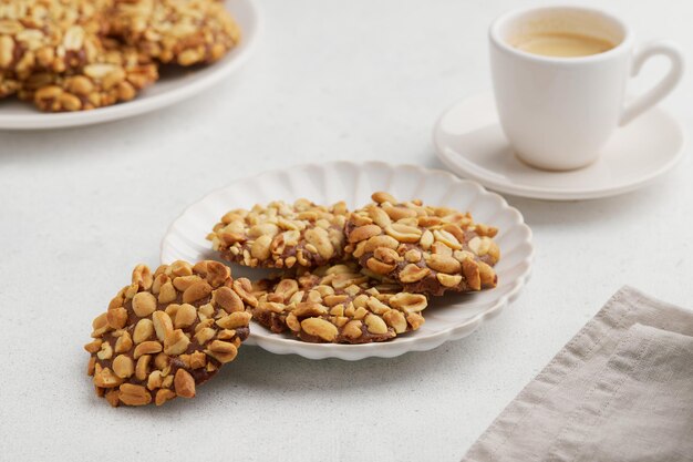 A heap of portugues traditional peanut cookies known as bolachas de amendoim on the white plate