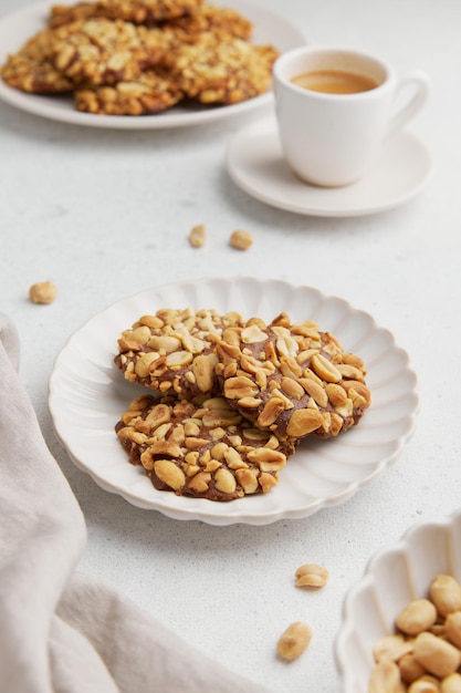 A heap of portugues traditional peanut cookies known as bolachas de amendoim on the white plate