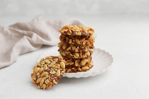 Photo a heap of portugues traditional peanut cookies known as bolachas de amendoim on the white plate