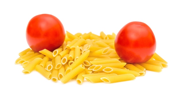 Heap of raw pasta with tomatoes on white
