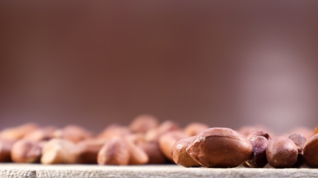 Heap of raw peanuts. Cultivated peanuts, underground or groundnuts. Plant of the legume family. Agricultural crop on an industrial scale. South America is considered the birthplace of peanuts.